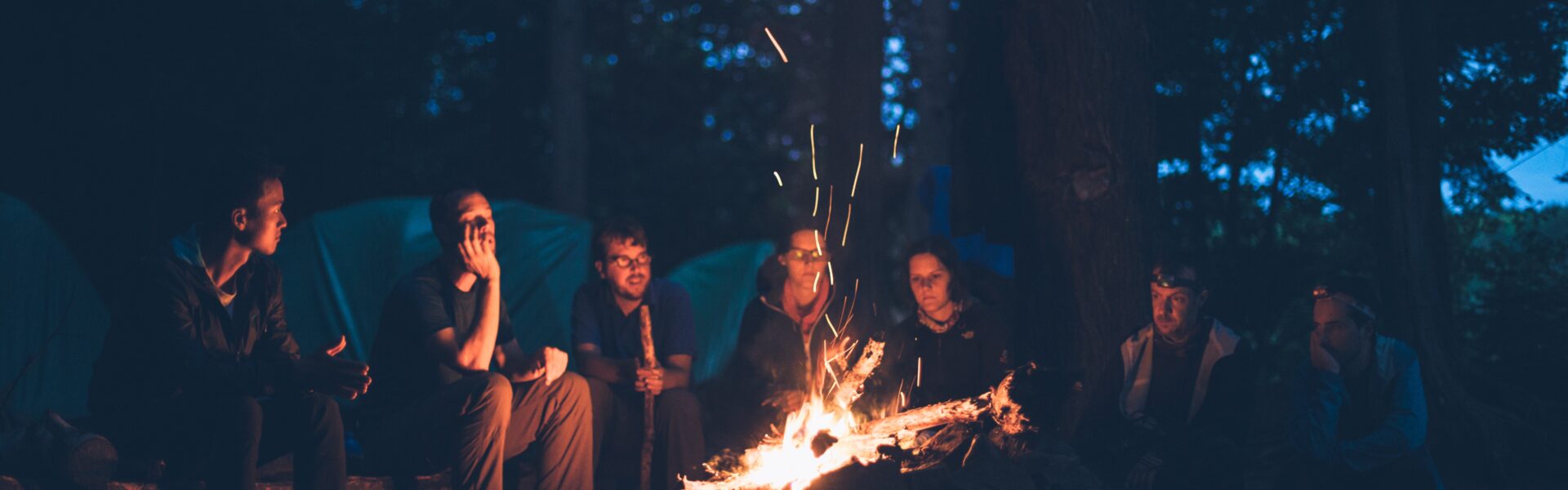 group of people camping fire